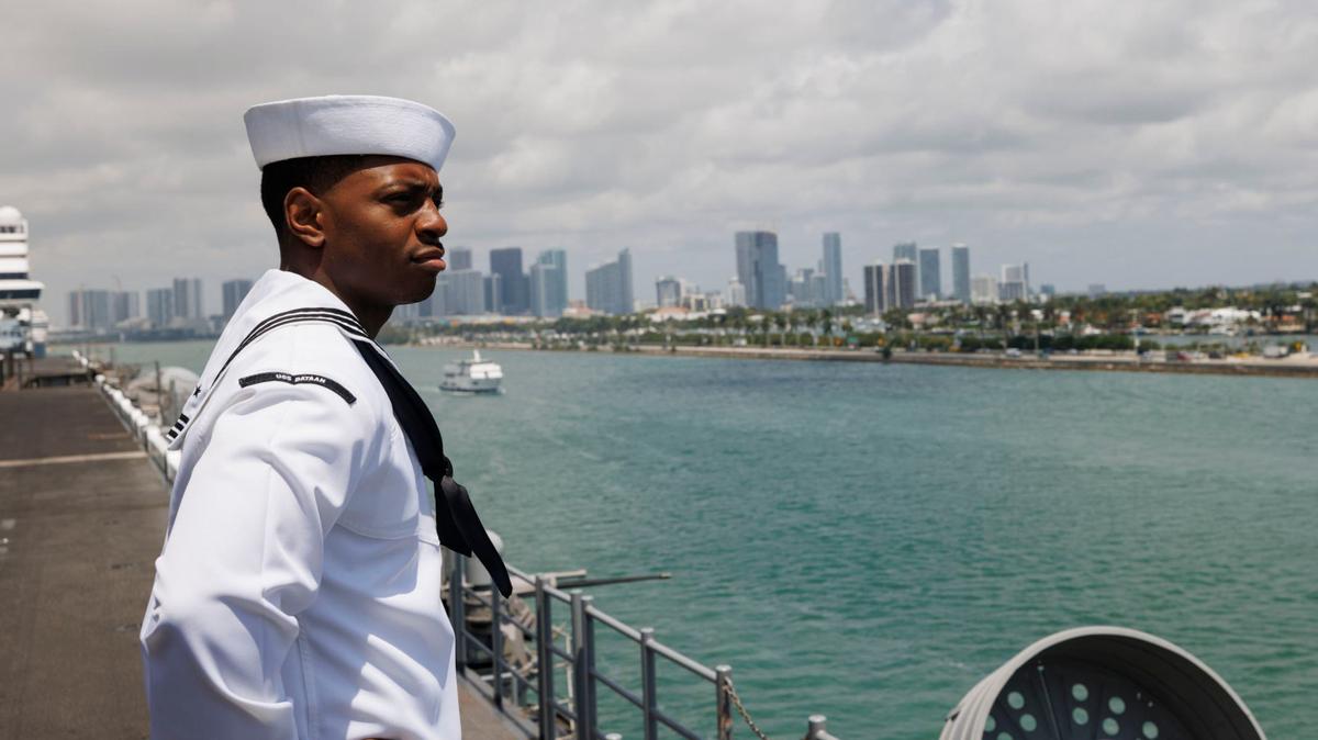 Erick Washington, religious program specialist, looks out at the bay and downtown Miami from the flight deck of the USS Bataan during the opening day of Fleet Week on Monday, May 6, 2024, at Norwegian Cruise Lines Terminal in PortMiami.
