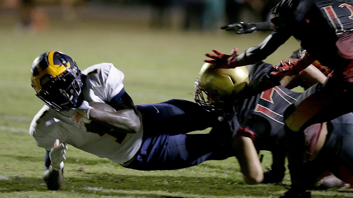 Belen’s Don Chaney Jr. #1 (RB), gets tackled by Pace’s Thomas Willis # 17(DB), during the first quarter of the Belen Jesuit Preparatory School vs MSGR.Pace Spartans Varsity high school football game at MSGR High School Field on Friday, November 02, 2018.
