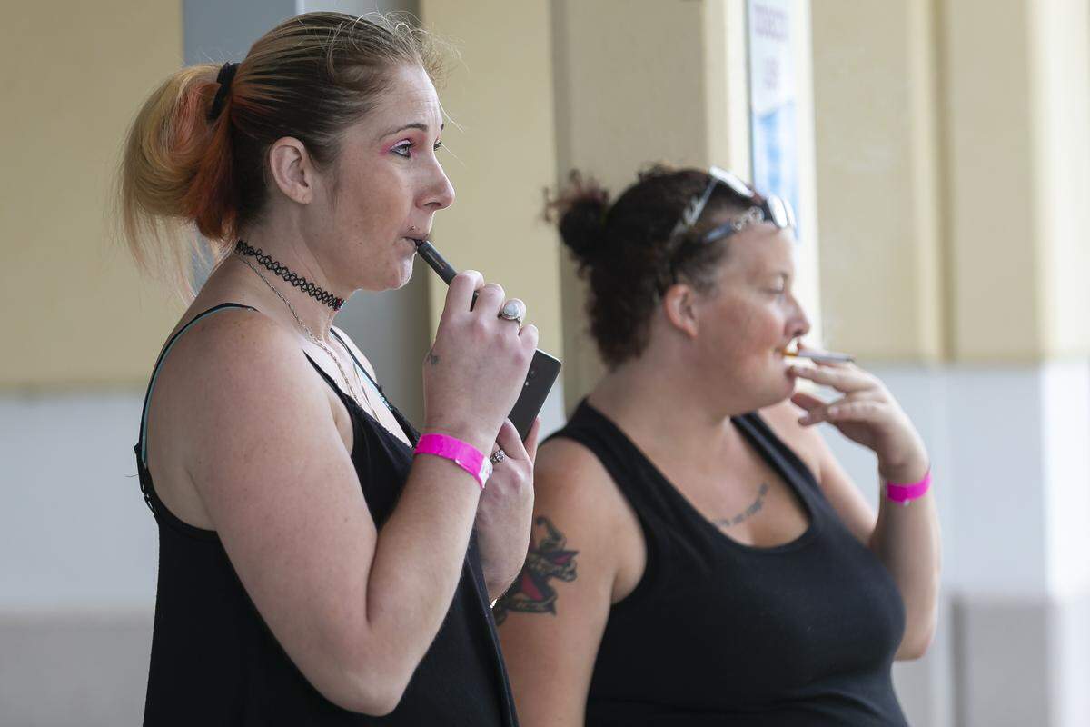 Stefanie Passieux, 35, left, and her friend, Samantha Cramer, 26, smoke outside Fort Pierce Central High School, one of St. Lucie County’s five shelters, on Monday, Sept. 2, 2019, as Hurricane Dorian inched closer to Florida’s Treasure Coast.