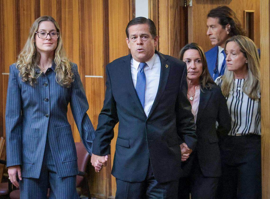 Real estate broker George Pino, center, walks into court holding the hands of his daughter, Carolina Pino, left, and wife, Cecilia Pino, right, as his attorney, family members, and supporters gathered inside Courtroom 4-1 at the Richard E. Gerstein Justice Building on Thursday, November 21, 2024, in Miami, Florida.