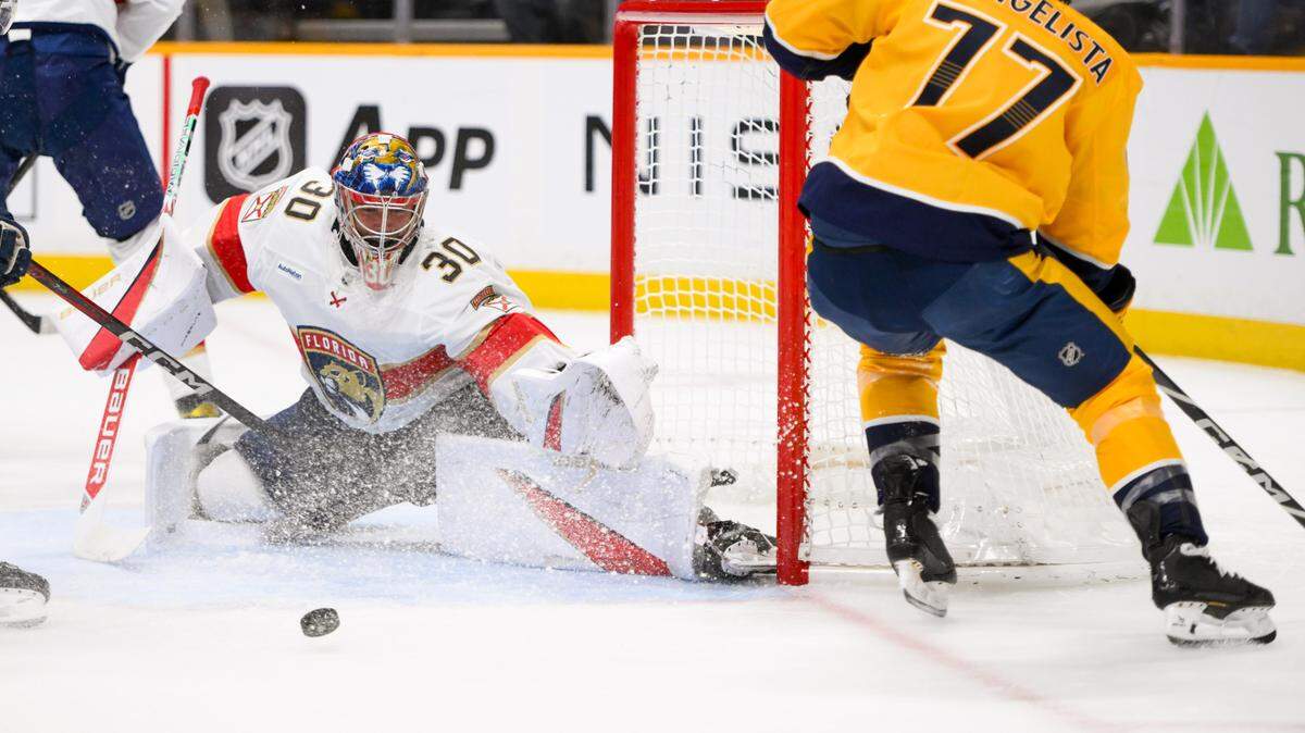 Feb 25, 2025; Nashville, Tennessee, USA; Florida Panthers goaltender Spencer Knight (30) blocks the shot of Nashville Predators right wing Luke Evangelista (77) during the first period at Bridgestone Arena. Mandatory Credit: Steve Roberts-Imagn Images