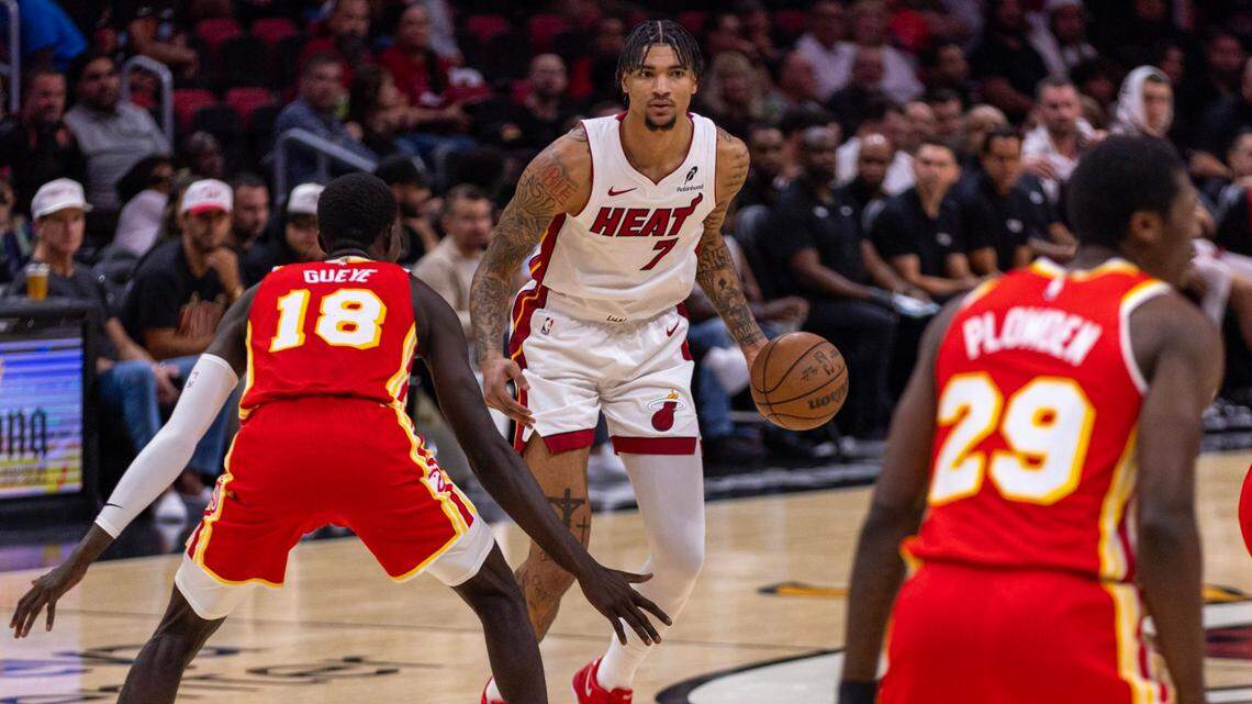 Miami Heat center Kel’el Ware (7) dribbles while defended by Atlanta Hawks forward Mouhamed Gueye (18) during the second half of an NBA preseason game at Kaseya Center on October 16, 2024, in Miami.