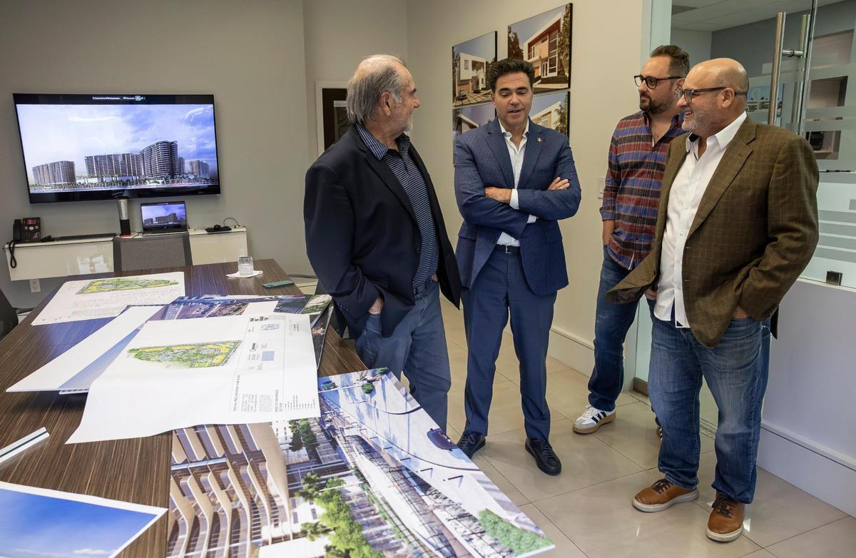 Miami-Dade attorney Felix Lasarte, second from left, talks with principal architects (from left to right) Mario Pascual, Andrew Starr and Peter Kiliddjian as they looked over renderings of proposed expansions to Trump National Doral at PPKS Architecture on Tuesday, Dec. 17, 2024, in Doral, Florida.