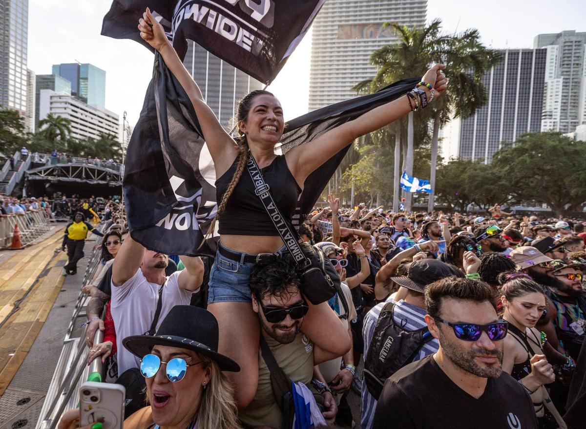 Camila Mendez carried by Alex Garcia react during live performance by Timmy Trumpet from the main stage at Ultra Music Festival’s 25th anniversary at Bayfront Park, in Miami, Florida, on Friday, March 28, 2025.