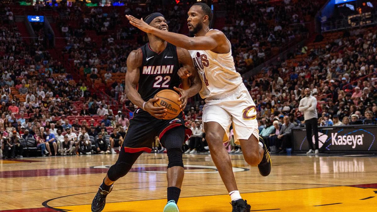 Miami Heat forward Jimmy Butler (22) drives on Cleveland Cavaliers forward Evan Mobley (4) during the first half of an NBA game at Kaseya Center in Miami, Florida, on Sunday, March 24, 2024.