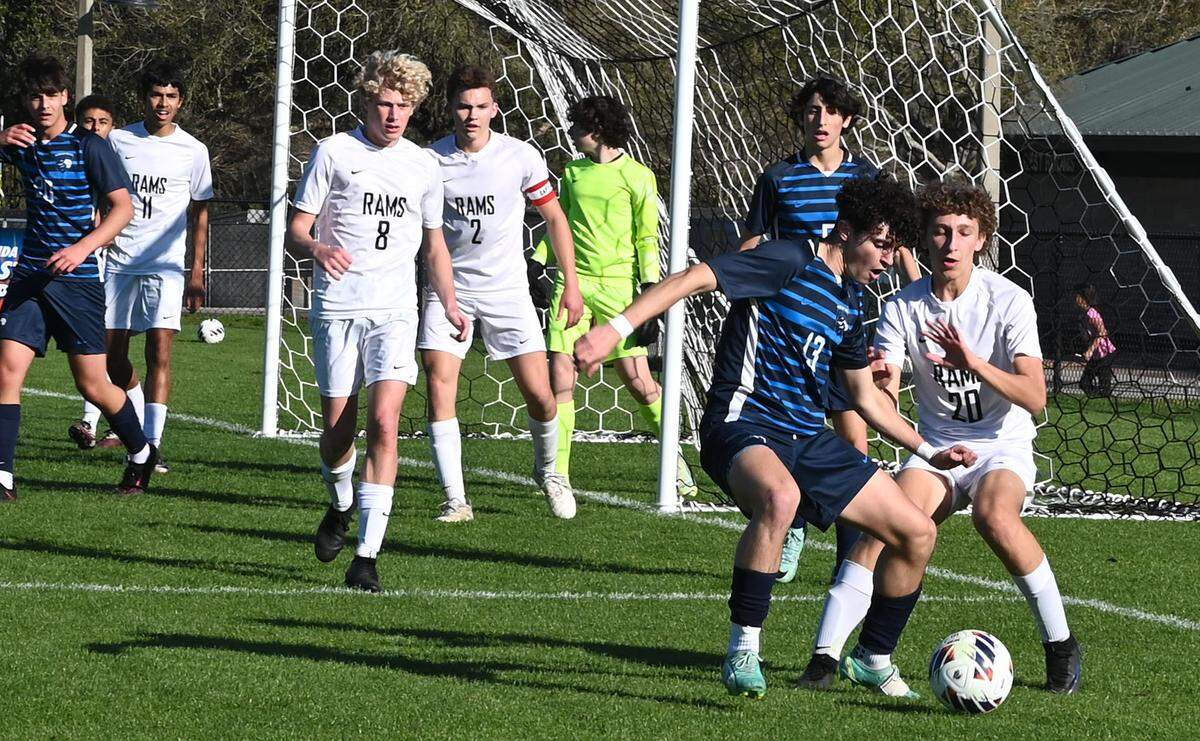 Scheck Hillel forward Adam Waich works the ball close to the Orangewood Christian goal while Bowen Nanton (20) defends for Orangewood during a Class 2A boys semifinal on Tuesday at Lake Myrtle Soccer Complex in Auburndale.