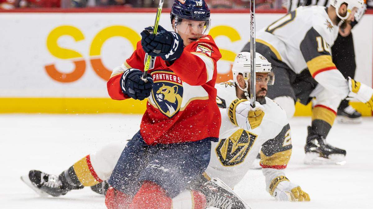 Florida Panthers center Anton Lundell (15) tries to take a shot toward the goal as Vegas Golden Knights left wing William Carrier (28) defends in the third period of Game 4 of the NHL Stanley Cup Final at the FLA Live Arena on Saturday, June 10, 2023, in Sunrise, Fla.