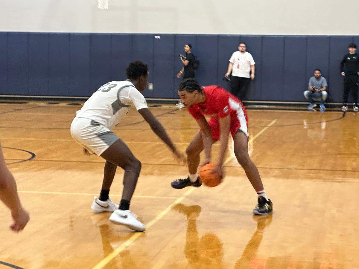 Westminster Academy’s Alex Constanza (right) prepares to try to dribble past Riviera Prep’s Laron Mack Jr. (left) during Monday’s Region 4-2A boys’ basketball semifinal at Riviera Prep.