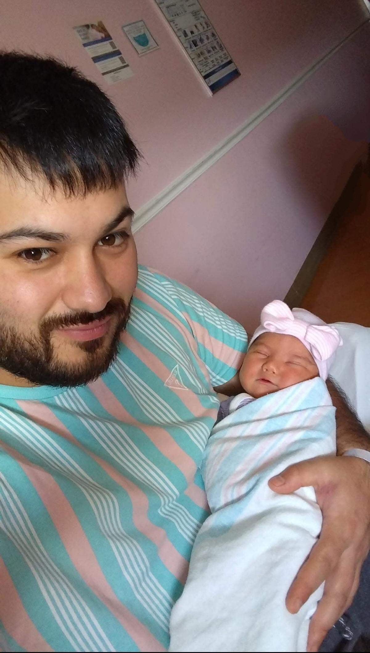 Nicolás Esbir with one of his children.