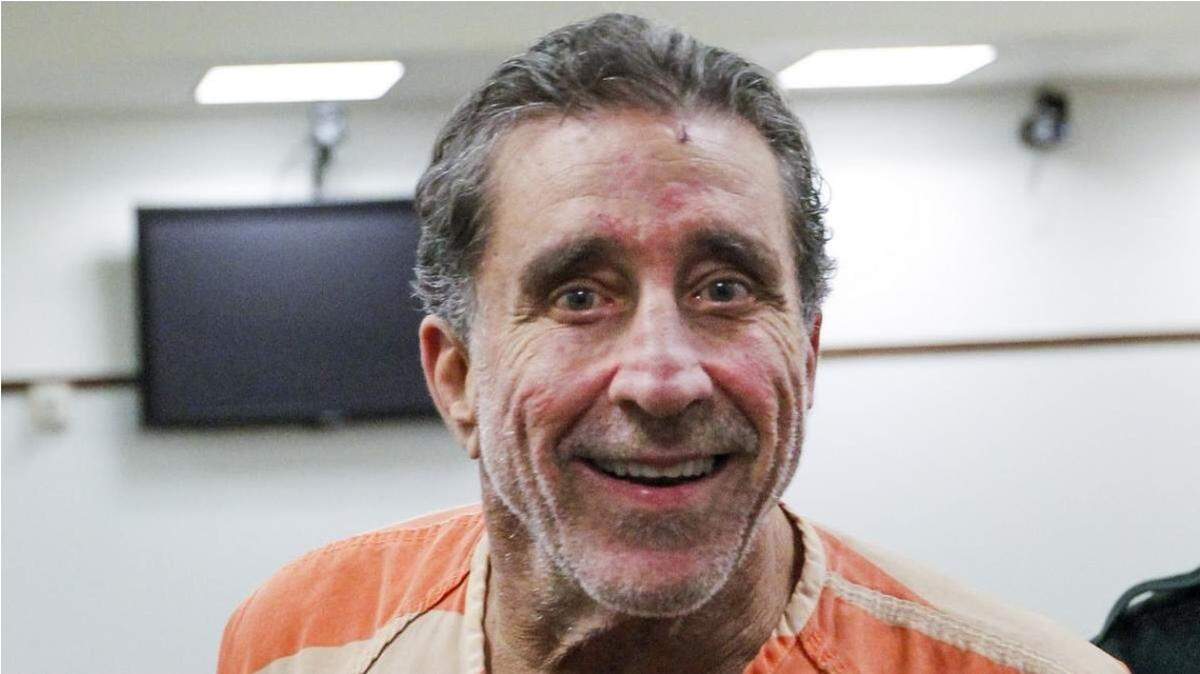 Ex-Port Richey mayor Dale Massad smiles as he is escorted from court after a March 14 court hearing at the West Pasco Judicial Center in New Port Richey.