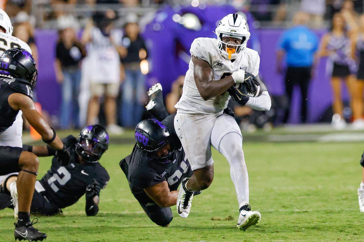 Sep 14, 2024; Fort Worth, Texas, USA; TCU Horned Frogs defensive lineman Caleb Fox (90) attempts a tackle on UCF Knights tight end Randy Pittman Jr. (5) during the fourth quarter at Amon G. Carter Stadium. Mandatory Credit: Andrew Dieb-Imagn Images