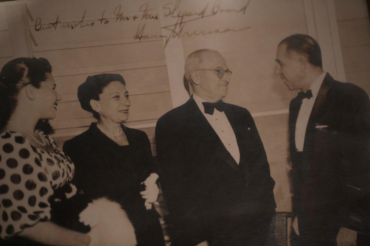 In this undated photo, Ann Bussel (left) with her mother, Ruth Broad, President Harry Truman and her father, Shepard Broad.