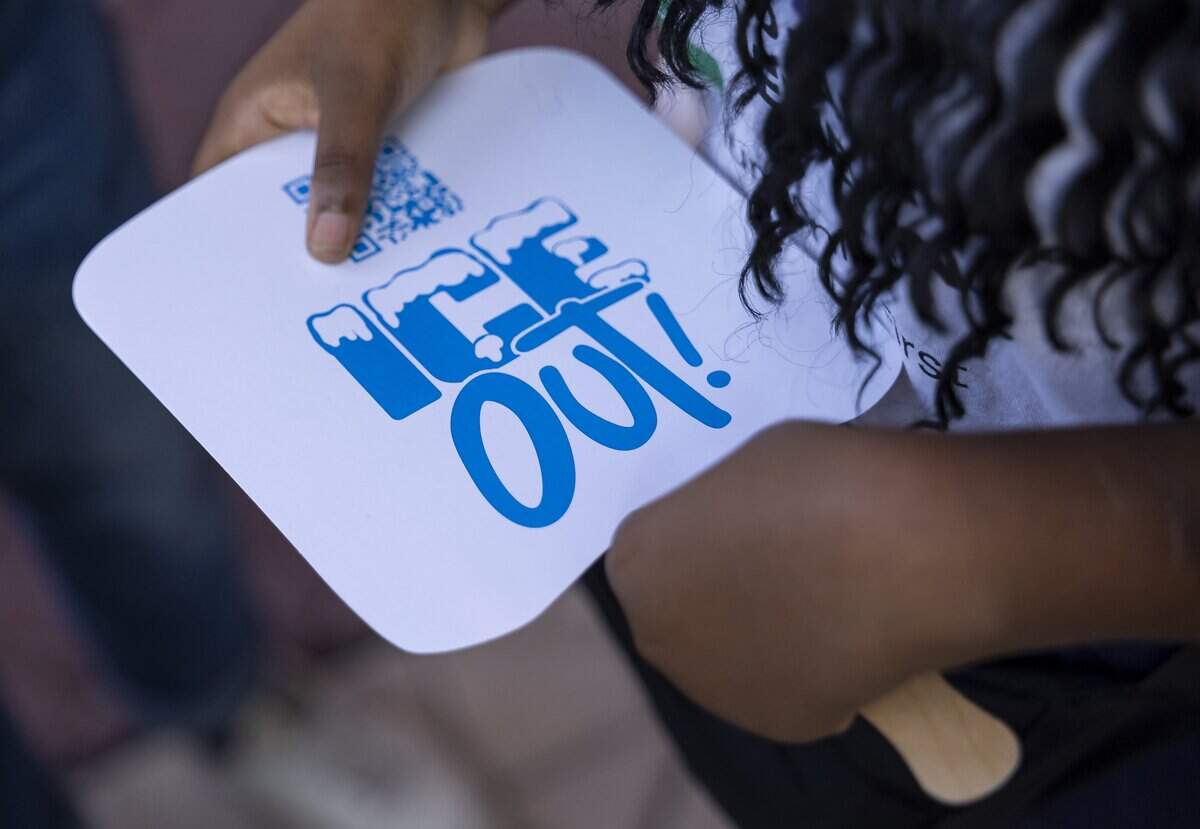 Mandy, an asylum seeker, holds a small fan as she attends a rally at the Little Haiti Cultural Center on Thursday, July 9, 2026, in Miami, Fla. The event called for protections for Temporary Protected Status (TPS) holders and other immigrants after the Trump administration stripped many of them of legal protections against deportation.