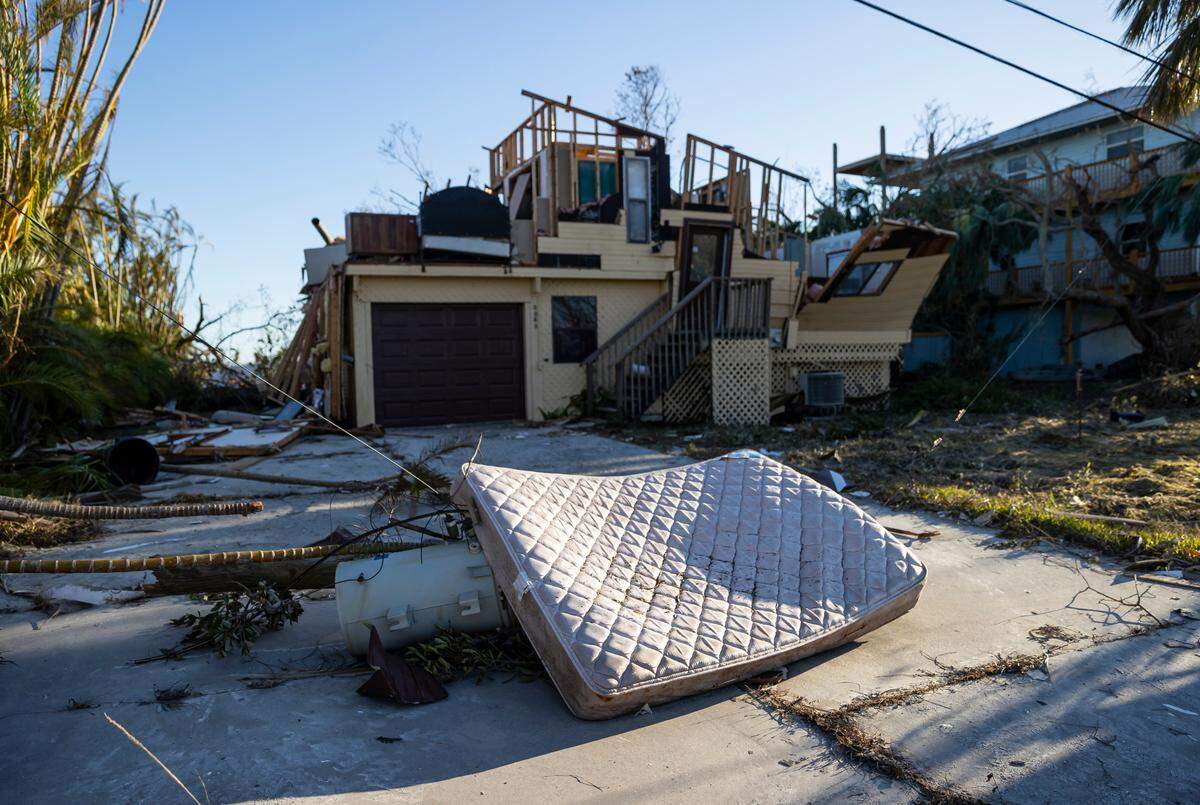 A mattress lays on top of an electrical transformer due to hurricane damage near a home on the southern tip of St. James City on Friday, Sept. 30, 2022, in Pine Island, Fla. Hurricane Ian made landfall on the coast of South West Florida as a category 4 storm Tuesday afternoon leaving areas affected with flooded streets, downed trees and scattered debris.