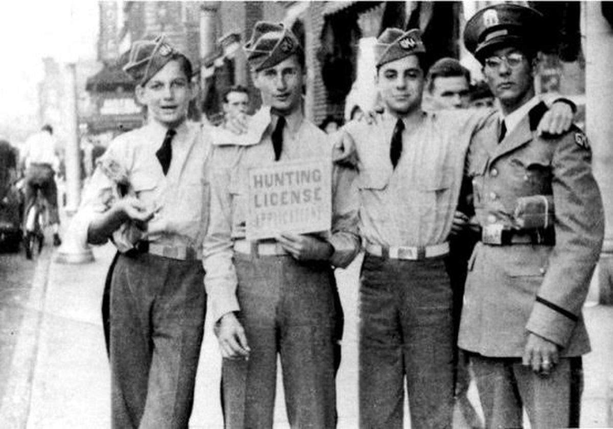 Norton Pallot, holding the sign, during World War II in 1945. He was 20 at the time.