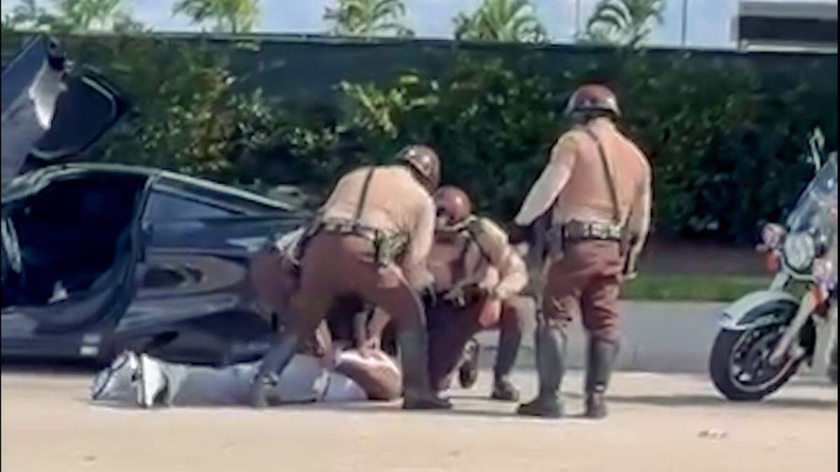 Photo capture from video shows Miami Dolphins’ Tyreek Hill being detained by Miami-Dade police on Sunday, Sept. 8, 2024, near Hard Rock Stadium before the Dolphins’ season opener against Jacksonville.