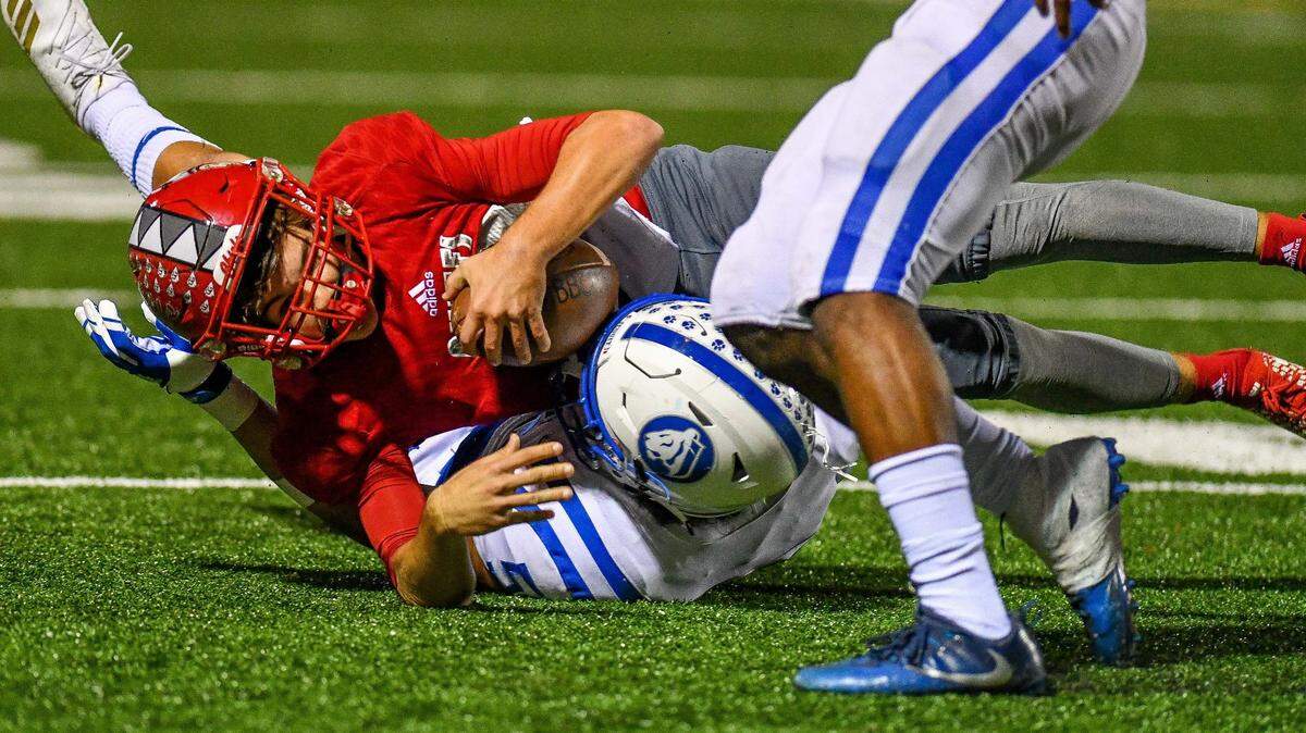 Cardinals’ quarterback Brody Palhegyi (12) holds on to the ball during the state semifinal football game between Jesuit and Cardinal Gibbons in Fort Lauderdale on Friday night, Nov. 30, 2018.