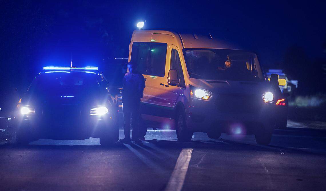 A Florida Highway Patrol trooper stands in between a patrol car and an exiting Ford van that arrived earlier as part of a motorcade to the migrant detention center, “Alligator Alcatraz,” located at the site of the Dade-Collier Training and Transition Airport in Ochopee, Florida on Wednesday July 02, 2025.