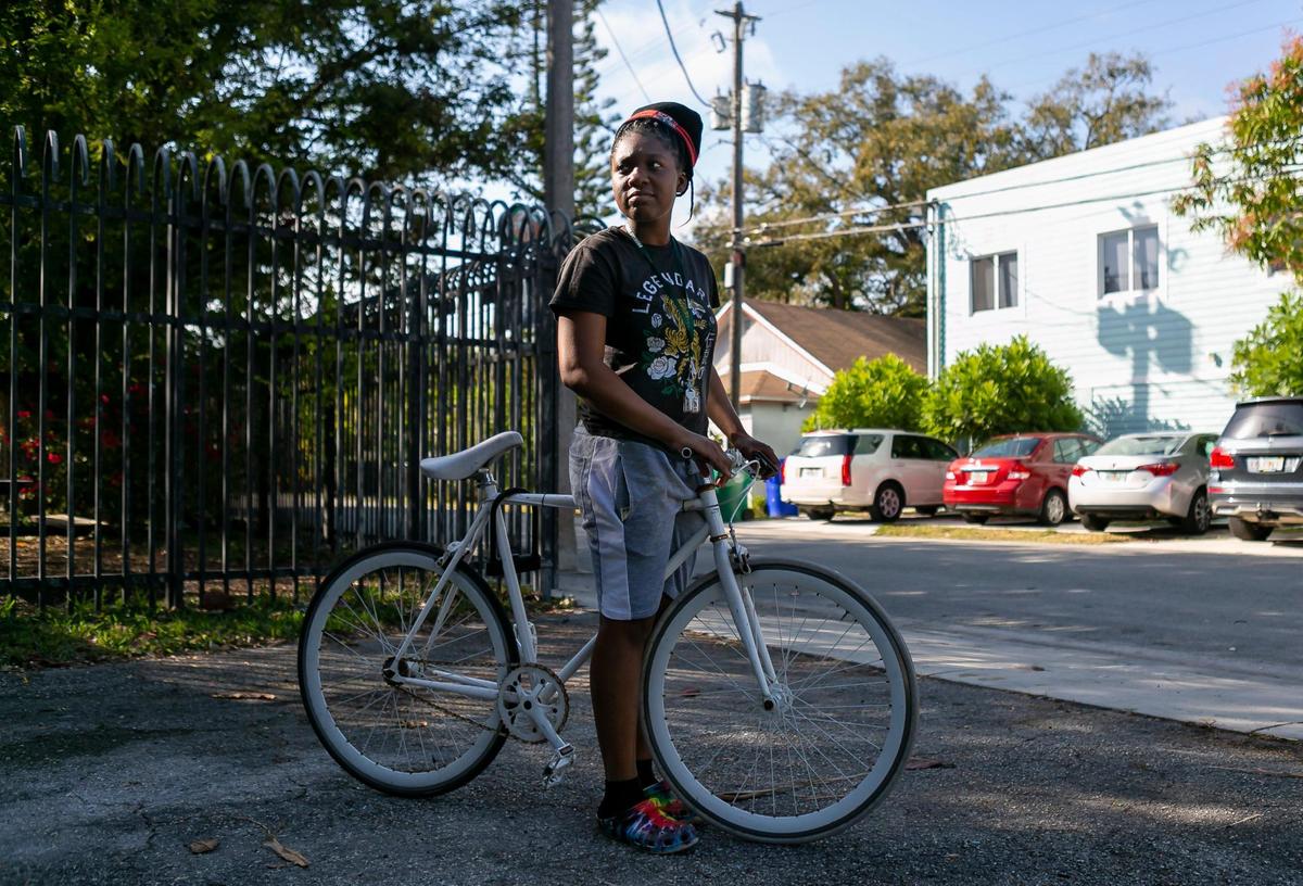 Rashardra Jenkins, 17, a junior at Law Enforcement Officers Memorial High School in downtown Miami, waits to pick up her nephew Irving Flood from the Barnyard, an after-school program in Coconut Grove, on Monday, Feb. 8, 2021. The Barnyard is part of Coconut Grove Cares, a nonprofit organization that provides free after-school and summer camp programs for children with financial hardships.