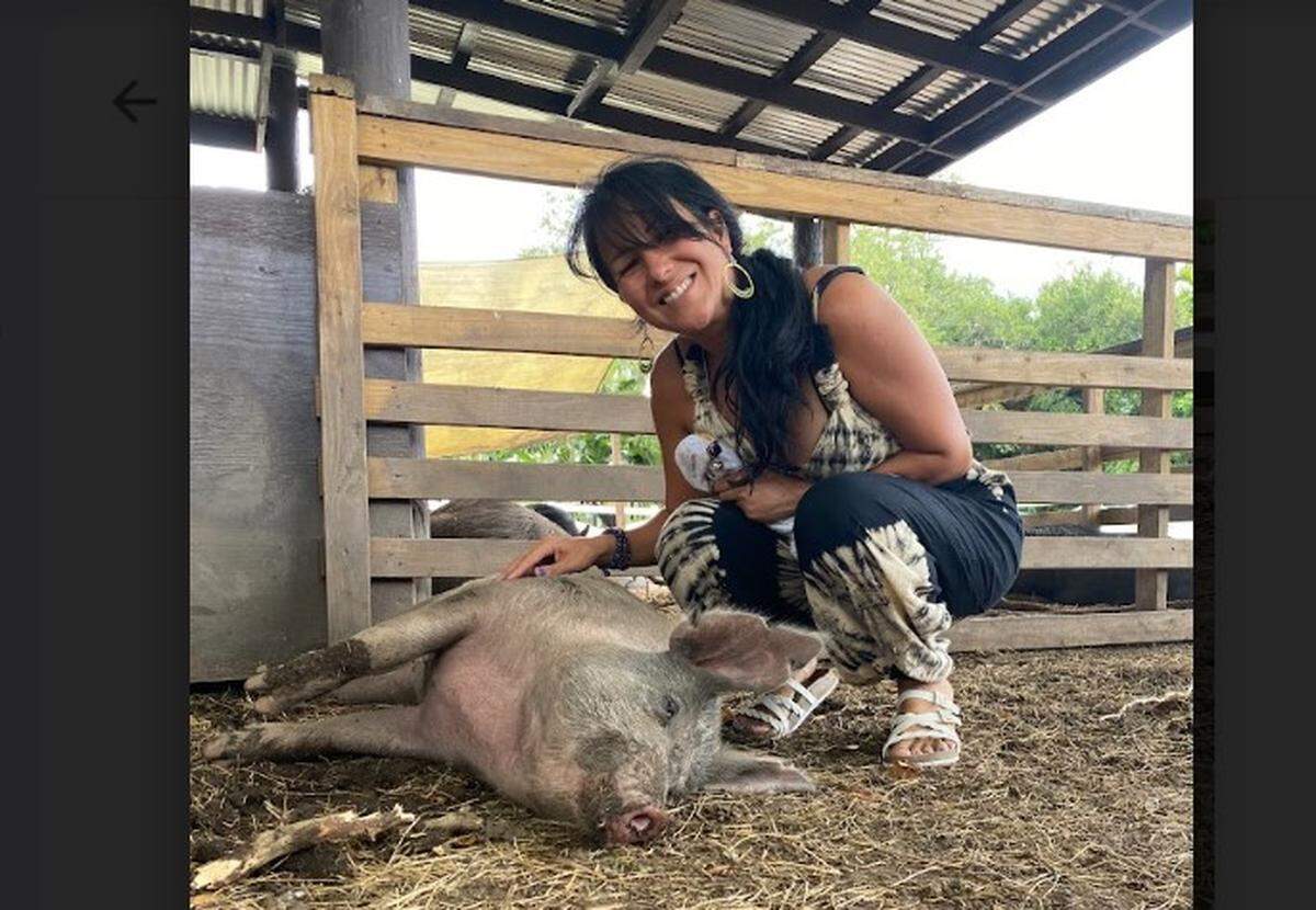 Aguacate Sanctuary owner Daney Cabrera with Chans the rescue pig who was pardoned in 2020