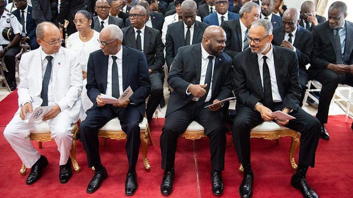 Haiti's Prime Minister Alix Didier Fils-AimÃ© (R, front row) sits with Transitional Presidential Council members Leslie Voltaire (L), Edgard Leblanc Fils (2nd L), and Smith Augustin (3L) as they attend a ceremony to mark 4 years since the assassination of former president Jovel Moise in Port-au-Prince, Haiti, on July 7, 2025. Moises was killed by armed gunmen at his home in a Port-au-Prince suburb on July 7, 2021. (Photo by Clarens SIFFROY / AFP) (Photo by CLARENS SIFFROY/AFP via Getty Images)
