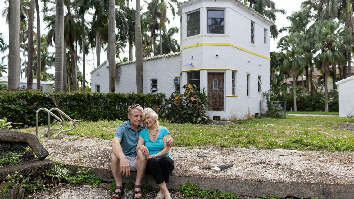 Penelope Johns, 74, and her husband, Karl Hupp, 73, hug outside of her former childhood home on Friday, Feb. 16, 2024, in Hollywood, Fla. The home, which used to belong to Johns’ mother and is almost 100 years old, might be torn down.