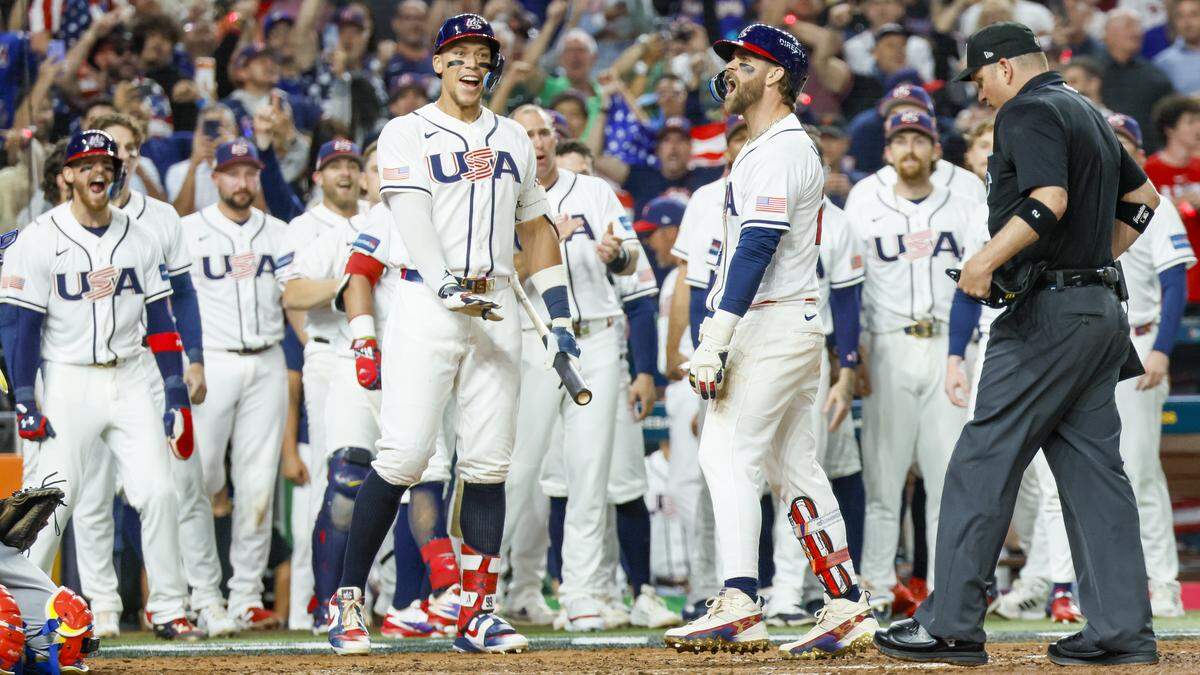 United States first baseman Bryce Harper (24) and Aaron Judge (99) celebrate at home plate after Harper hits a homerun in the eighth inning for the final game of the 2026 World Baseball Classic against Venezuela at loanDepot park on Tuesday, March 17, 2026. 