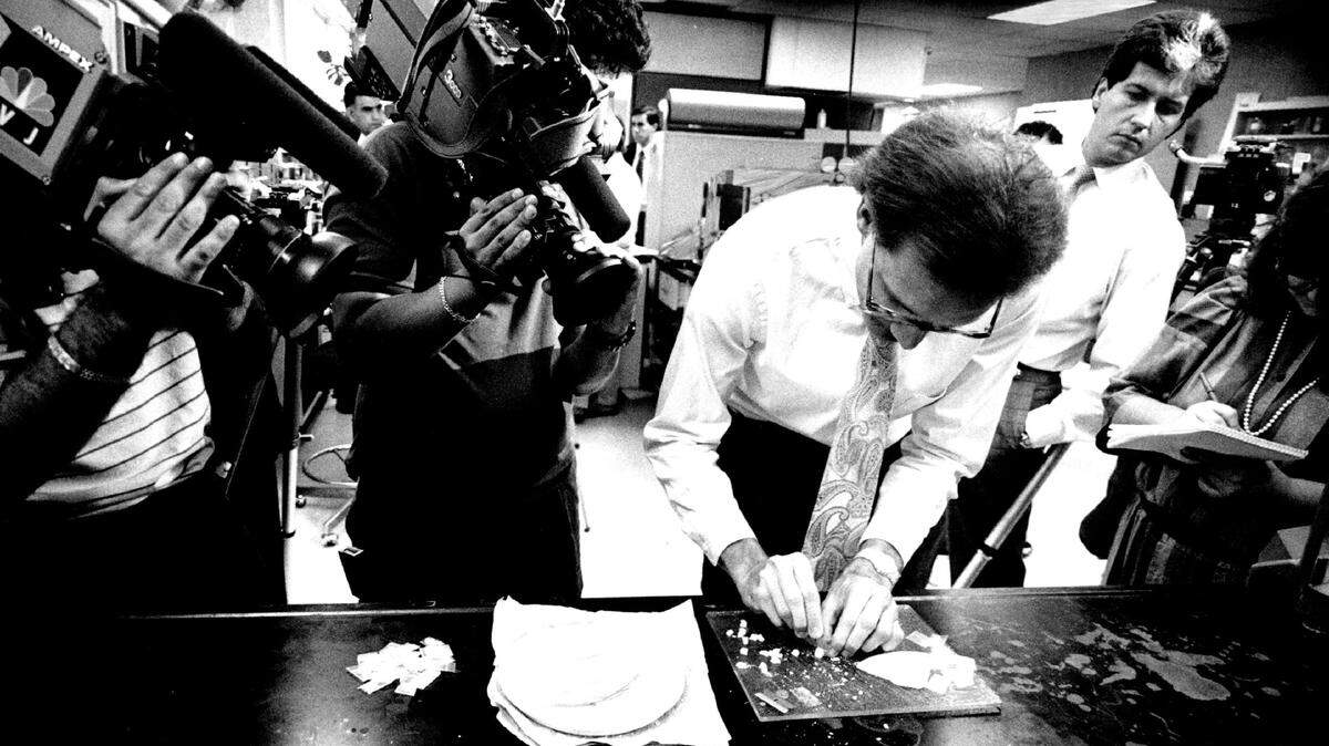 File photo of Broward Sheriff’s Office drug chemist Randy Hilliard cutting up crack as part of a cocaine crackdown.