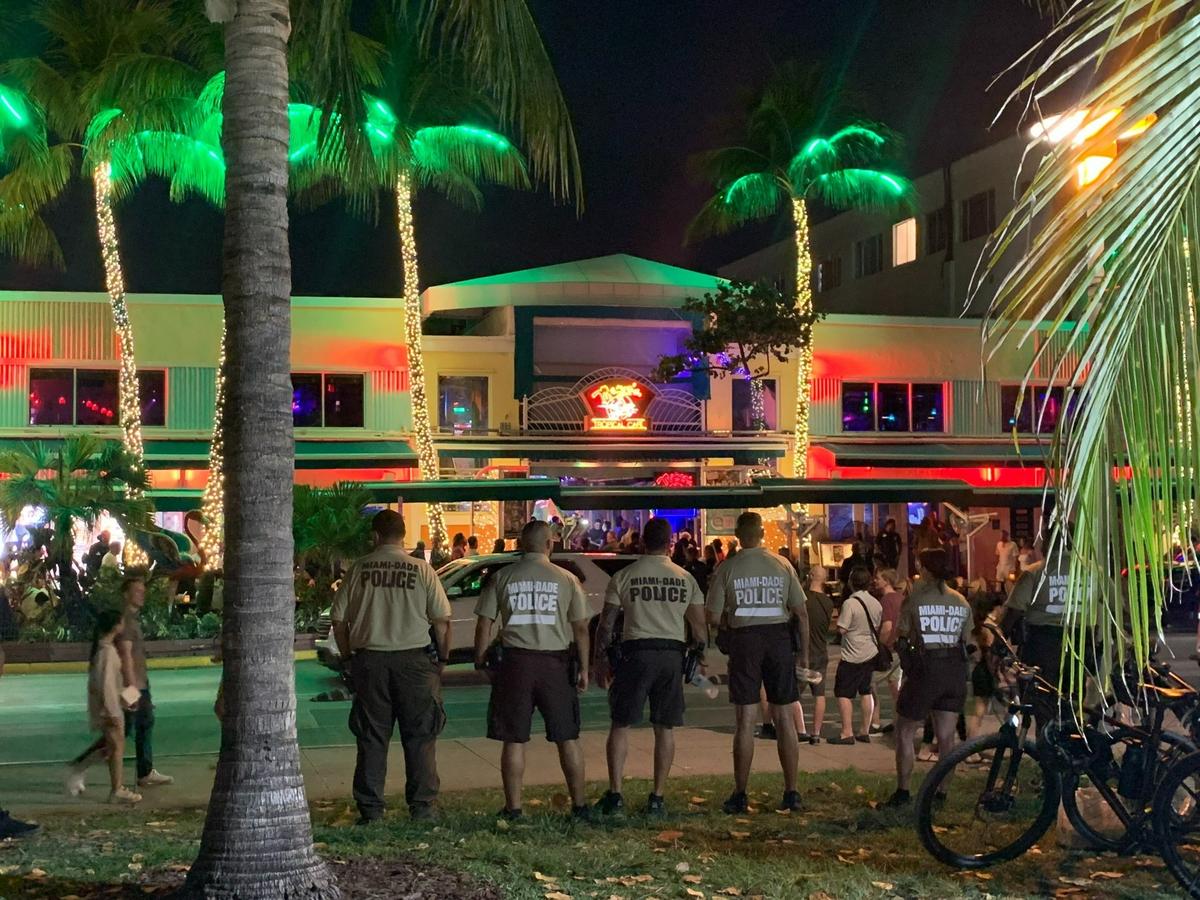 Miami-Dade police officers stand near Mango’s Tropical Cafe on Ocean Drive in Miami Beach on Saturday, March 4, 2023.