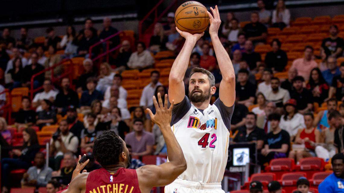 Miami Heat forward Kevin Love (42) shoots over Cleveland Cavaliers guard Donovan Mitchell (45) during the first half of an NBA game at Miami-Dade Arena in Downtown Miami, Florida, on Wednesday, March 8, 2023.