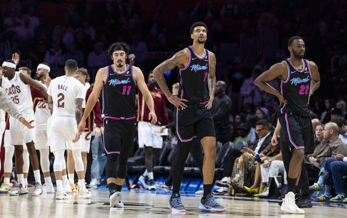 Miami Heat forward Jaime Jaquez Jr. (11), center Kel'el Ware (7) and forward Andrew Wiggins (22) react after the Cleveland Cavaliers scored in the second half of their NBA game at Kaseya Center on Nov. 12, 2025, in Miami.