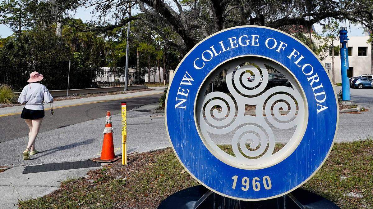 A student makes her way past the sign at New College Friday, Jan. 20, 2023, in Sarasota.