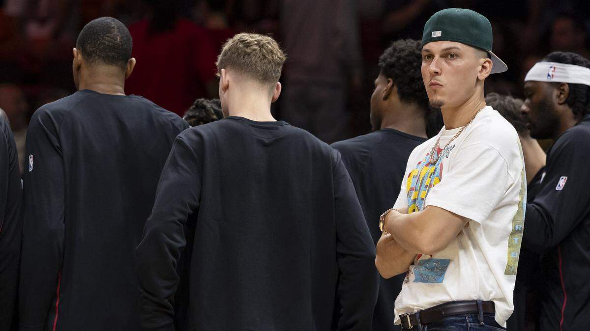 Miami Heat guard Tyler Herro (14) looks on during a timeout as his team plays against the Memphis Grizzlies in the first half of their NBA preseason game at Kaseya Center on Oct. 17, 2025, in Miami.