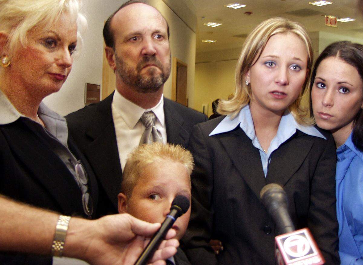 The Book family talks to reporters on Oct. 10, 2002, after hearing Circuit Judge Ilona Holmes sentence their former live-in babysitter to 15 years in prison for sexually assaulting daughter Lauren, fourth from left. In the photo are: Patricia Book, Ron Book, their son Chase, 11, and daughters Lauren, 17, and Samantha, 15. Waldina Flores pleaded no contest to five counts of sexually molesting Lauren Book over a five-year period when she was the family’s trusted live-in childcare worker. “She hurt me,” Lauren told the court.