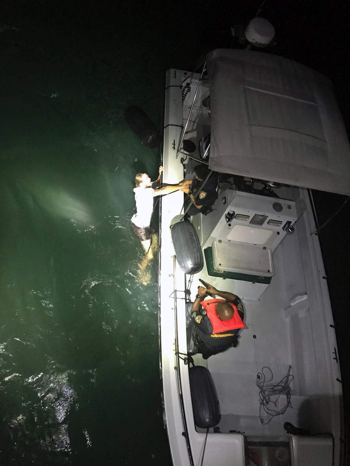 Key Colony Beach Police pull Nicholas Tralka onto a Florida Fish and Wildlife Conservation Commission boat