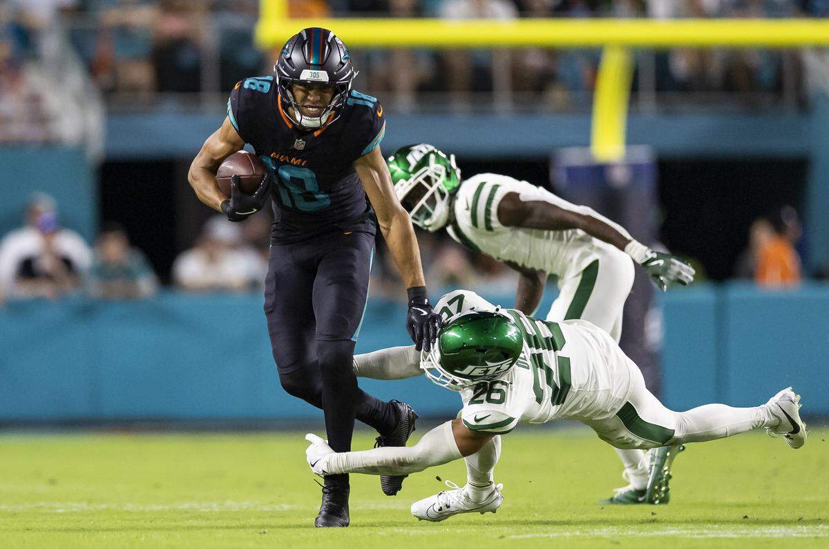 Miami Dolphins wide receiver Nick Westbrook-Ikhine (18) runs with the ball as New York Jets safety Isaiah Oliver (26) tackles him in the second half of their NFL game at Hard Rock Stadium on Monday, Sept. 29, 2025, in Miami Gardens, Fla.
