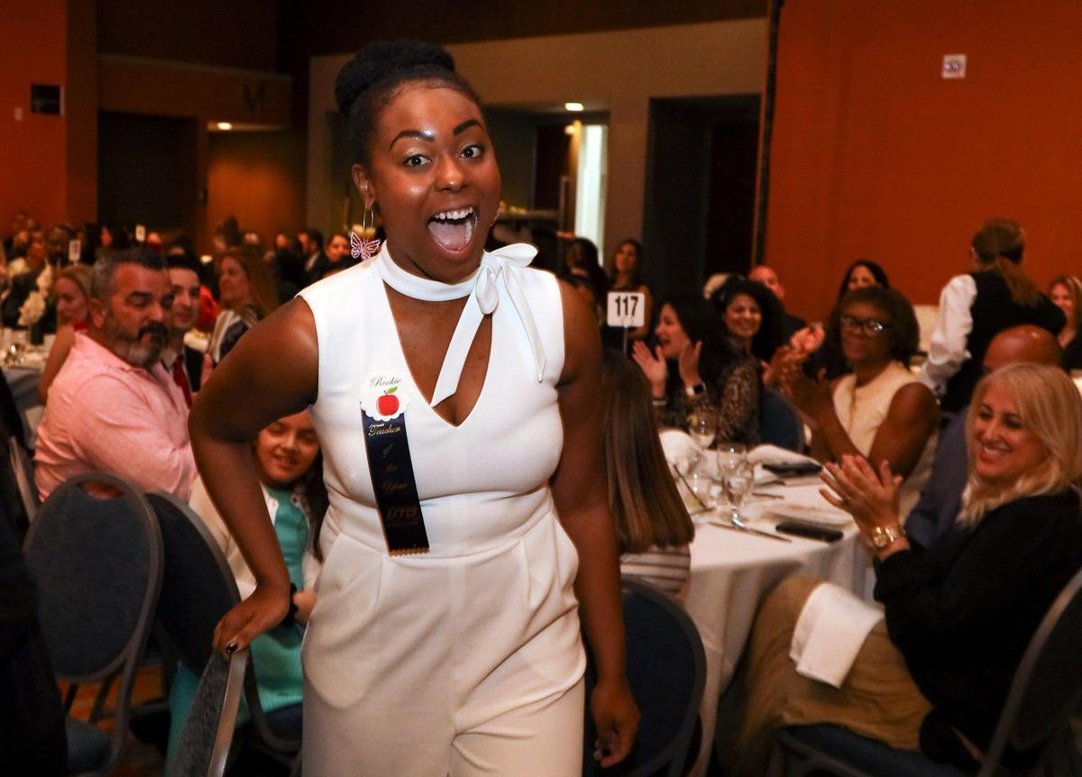 Kalyn Lee of Miami Carol City High is the 2021 Francisco R. Walker Rookie Teacher of the Year. Lee is congratulated by friends and family as she heads up to the stage to receive her award.