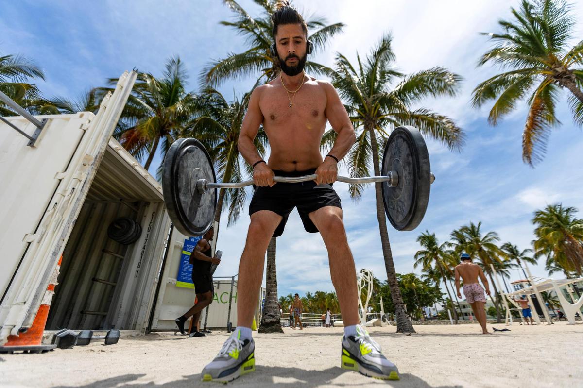 Tony Cucciniello, 38, lifts weights at Muscle Beach during Memorial Day weekend at Miami Beach, Florida, on Monday, May 29, 2023.