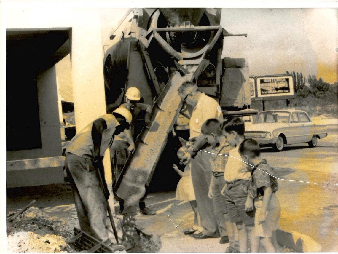 In this family photo from the early 1960s, Sunset Corners, founded in December 1954 by Bernard Rudnick (top right) oversees the first upgrade of his store. He and his grandchildren throw pennies in the concrete, a tradition to bring good prosperity. Wendy Bittel Gelbard, Larry Solomon, Michael Bittel and Stephen Bittel.
