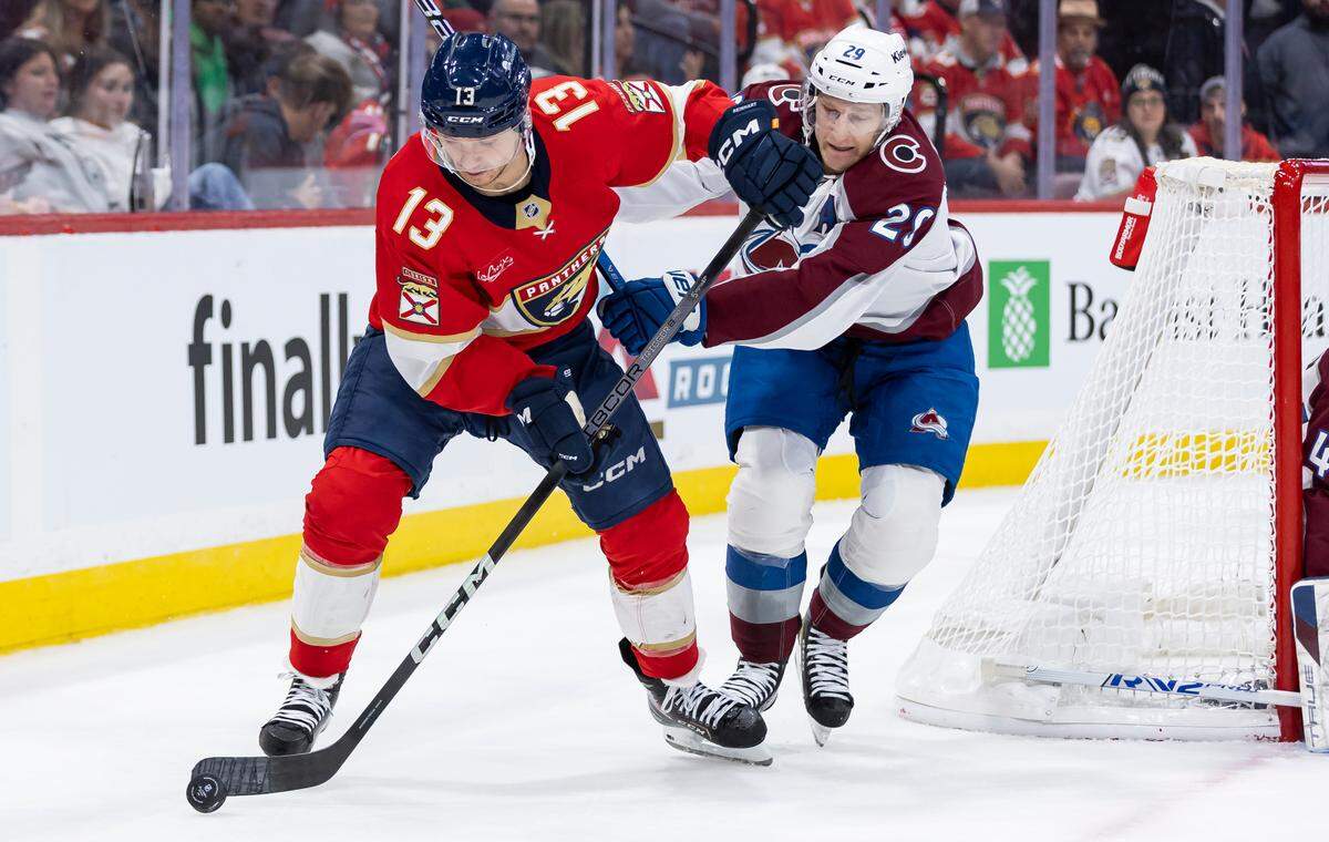 Florida Panthers center Sam Reinhart (13) and Colorado Avalanche center Nathan MacKinnon (29) compete for the puck in the first period of their NHL game at Amerant Bank Arena on Saturday, Nov. 23, 2024, in Sunrise, Fla.