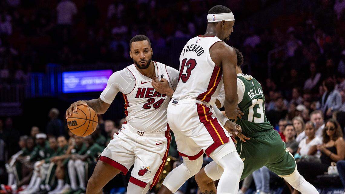 Miami Heat guard Norman Powell (24) uses rhetorical screen by center Bam Adebayo (13) as Milwaukee Bucks guard Ryan Rollins (13) attempts to defend during the first half of an preseason NBA game at Kaseya Center on Monday, October 6, 2025, in Miami, Fla.