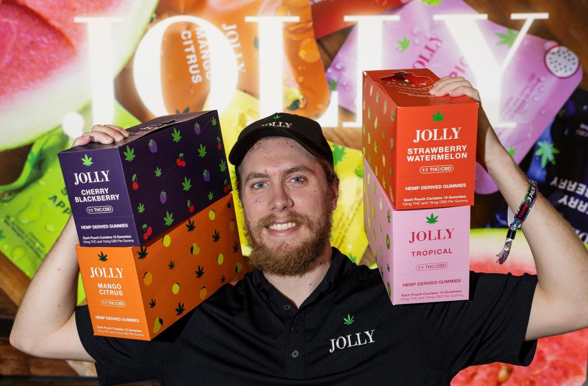 Josh Gleason, JOLLY sales manager, hold some of his company’s products while attending the CHAMPS Trade Show at the Broward County Convention Center on Thursday, Oct. 17, 2024, in Fort Lauderdale, Fla.