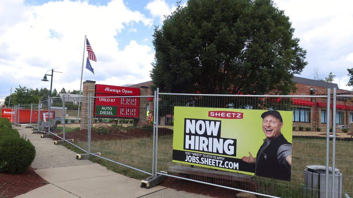 In this Aug. 18, 2020 photo, a “Now Hiring” sign hangs in front of a Sheetz convenience store and gas station under construction in Wexford, Pa. On Thursday, Nov. 19, 2020, the number of Americans seeking unemployment aid rose last week to 742,000,  the first increase in five weeks and a sign that the resurgent viral outbreak is likely slowing the economy and forcing more companies to cut jobs. (AP Photo/Ted Shaffrey)