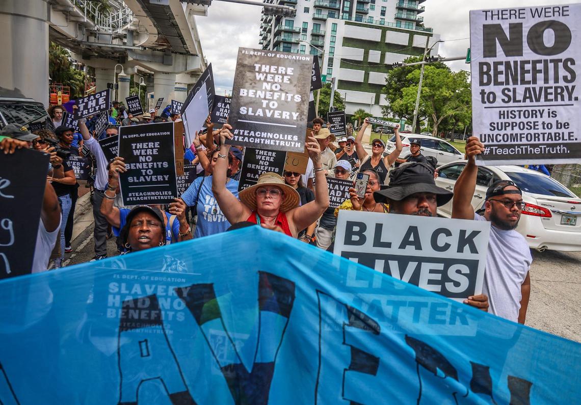 A group of roughly 80 protesters joins with members of the Teamsters National Black Caucus after arriving outside the Miami-Dade School Board administration building in protest of the new African American history standards approved by the state in July, Wednesday, Aug. 16, 2023 in Miami, Florida.