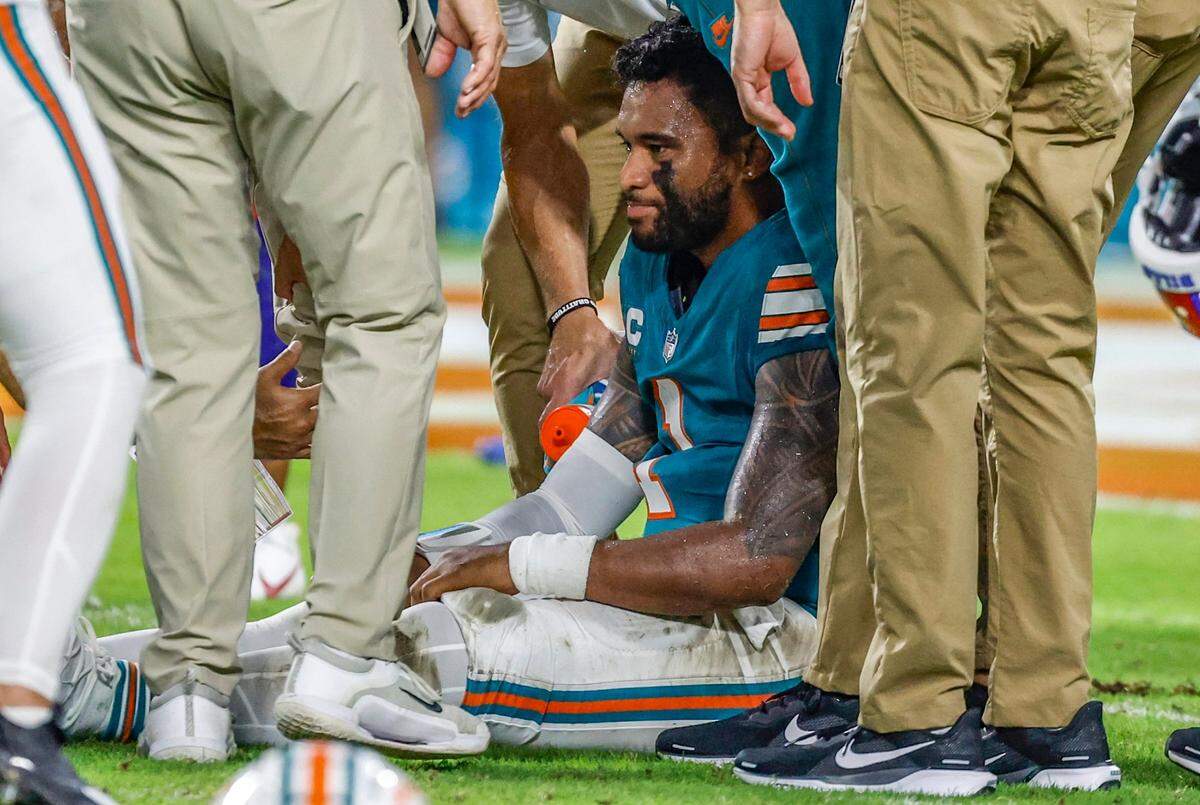 Miami Dolphins quarterback Tua Tagovailoa (1) sits on the field as he is attended to after an injury during the game against the Buffalo Bills in the second half in an NFL game at Hard Rock Stadium on Thursday, September 12, 2024.