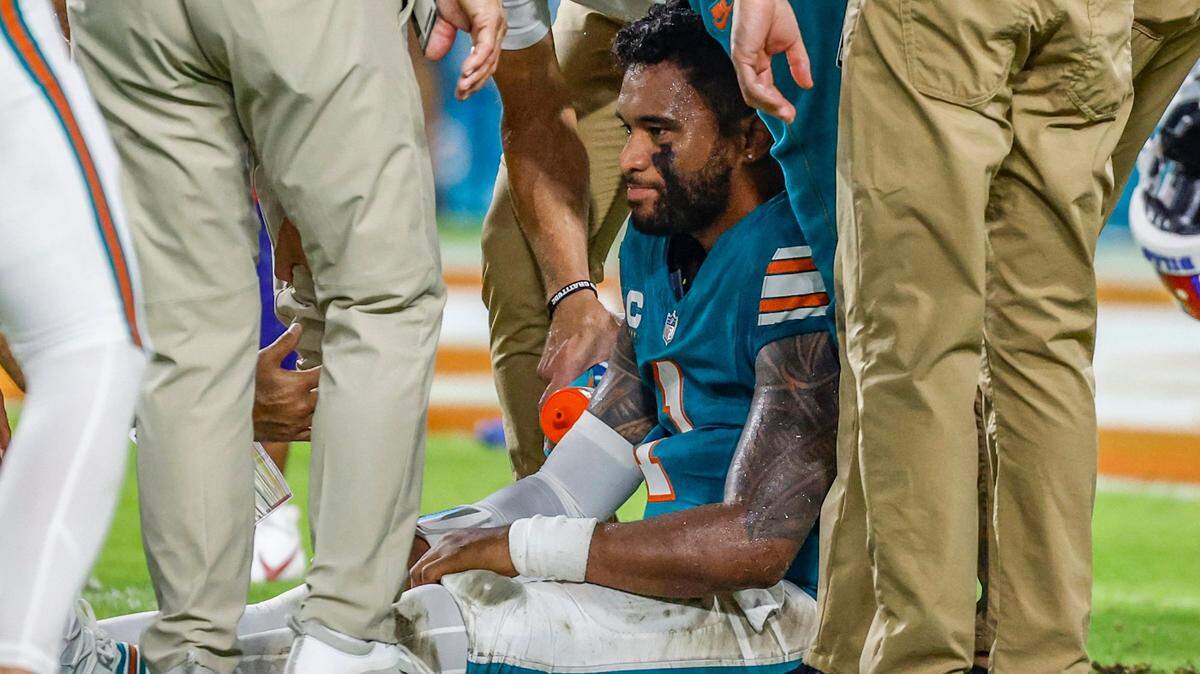 Miami Dolphins quarterback Tua Tagovailoa (1) sits on the field as he is attended to after an injury during the game against the Buffalo Bills in the second half in an NFL game at Hard Rock Stadium on Thursday, September 12, 2024.