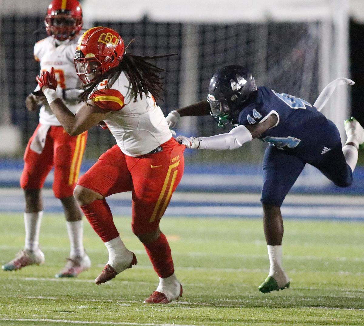 Deerfield Beach Bucks running back Jamaree Dukes (5) attempts to break free from Palmetto Panthers defender during the Class A 8 Regional semifinal football game on Thursday, November 18, 2021 Tropical Park Stadium. Andrew Uloza / for THE MIAMI HERALD