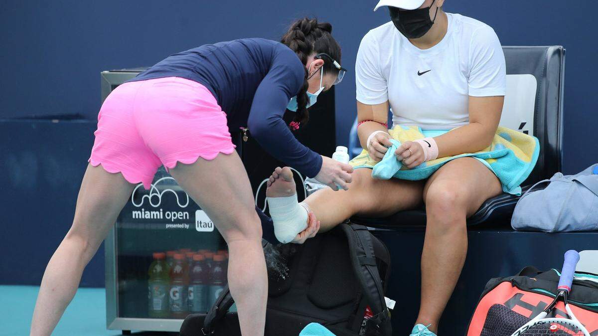 Bianca Andreescu of Canada is treated after injuring her ankle during the 2021 Miami Open tennis tournament at Hard Rock Stadium in Miami Gardens on Saturday, April 3, 2021. Ankle injuries are common in tennis.