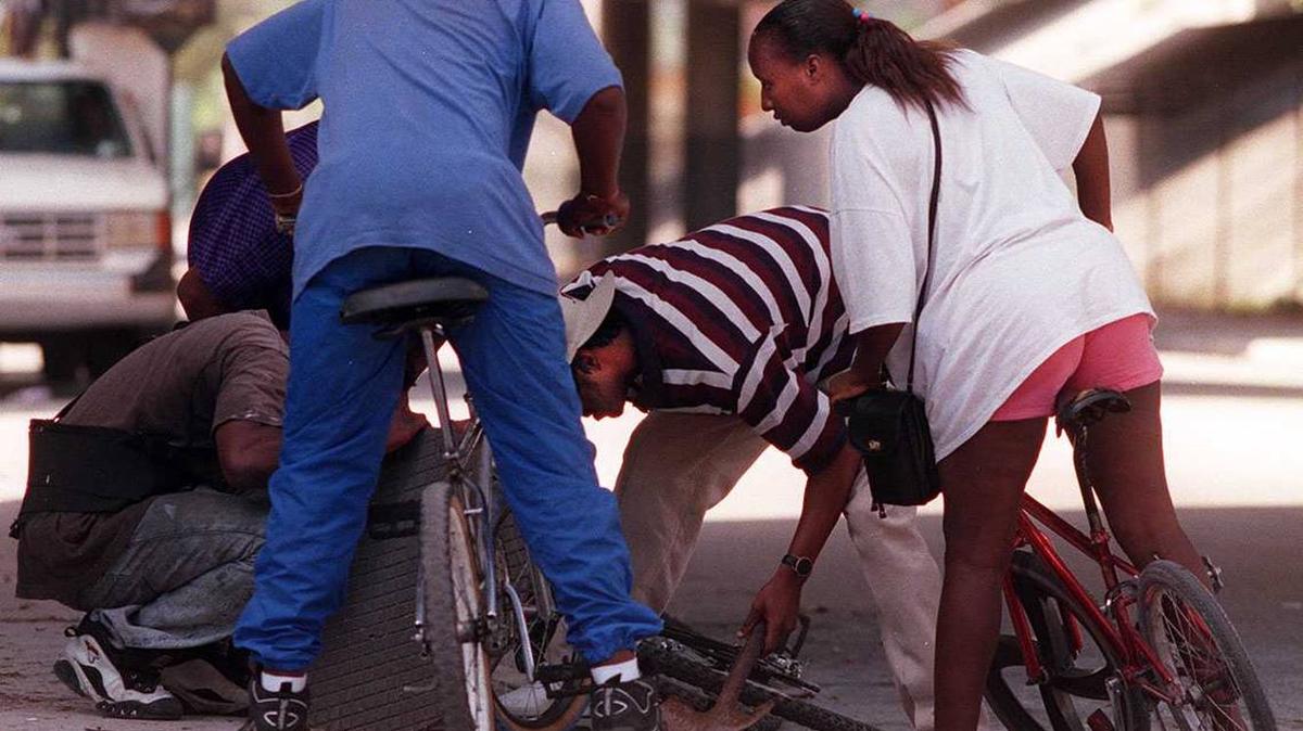 People look for the money after a Brinks truck cr ashed in Miami in 1997.