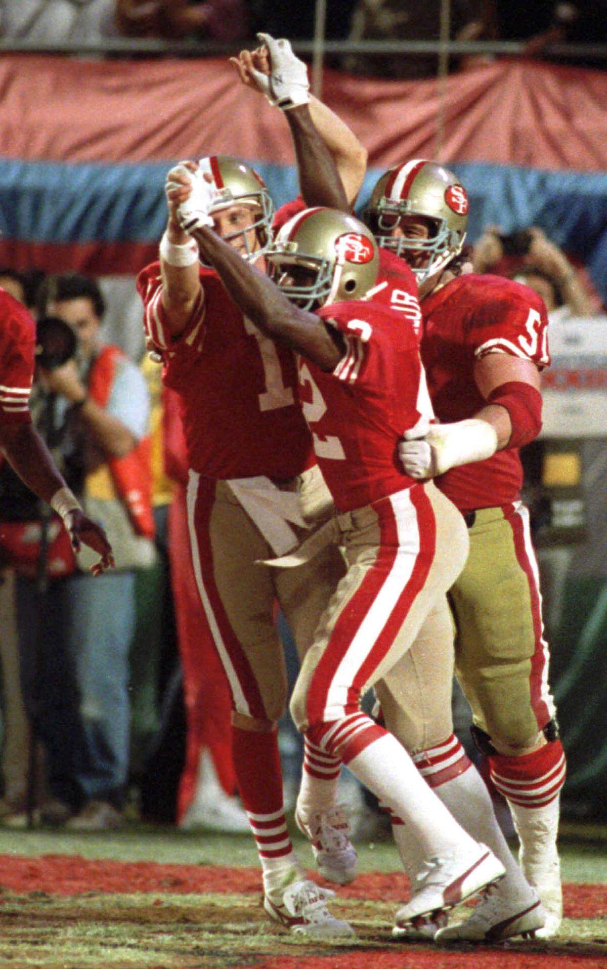 San Francisco 49ers quarterback Joe Montana (16) and wide receiver John Taylor (82) clasp hands after Montana’s pass to Taylor at the end of the fourth quarter resulted in a 20-16 victory over the Cincinnati Bengals at Super Bowl XXIII Jan. 22, 1989, in Miami.